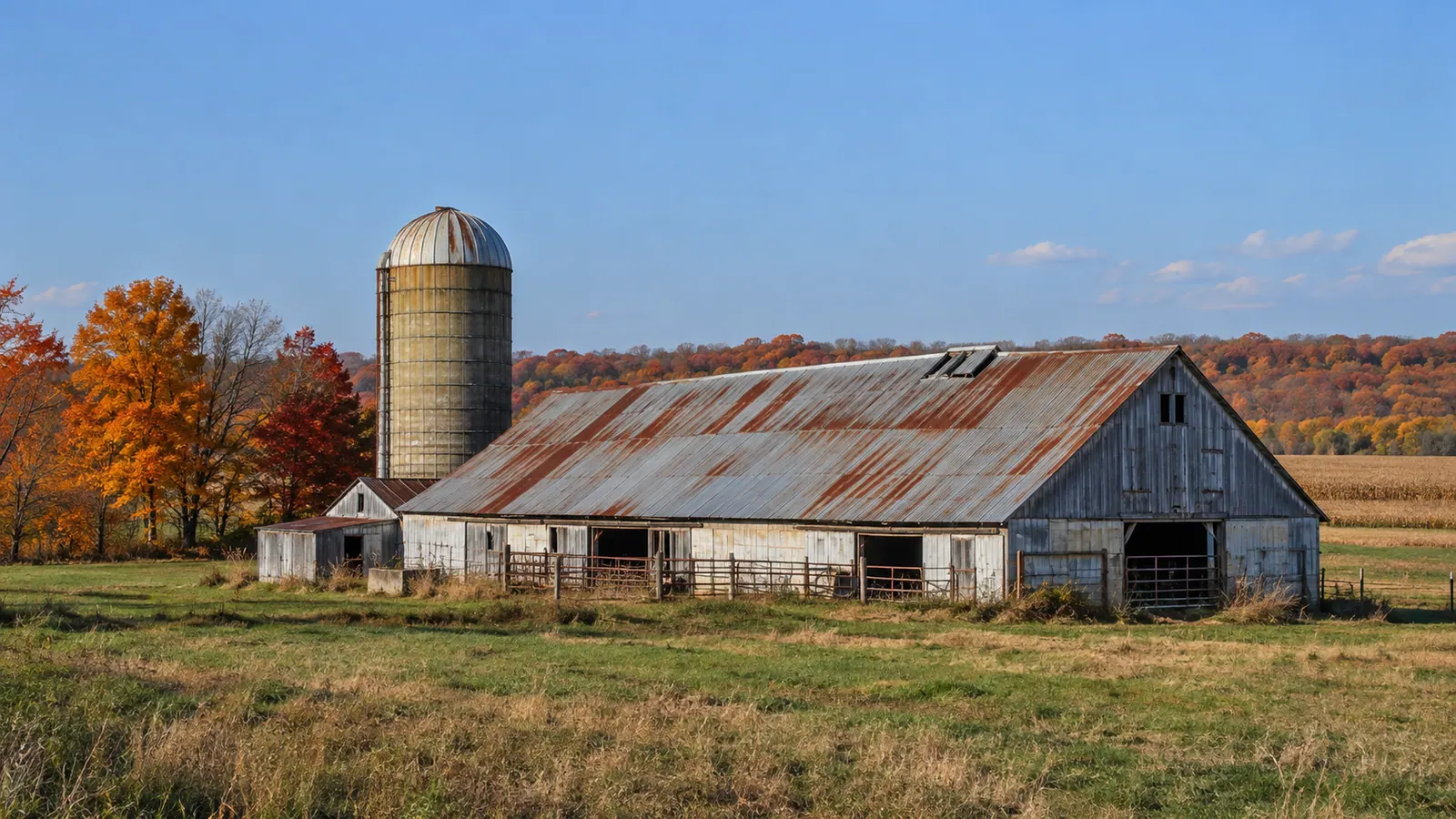 Weathered metal barn roof with rust and loose trim before repairs